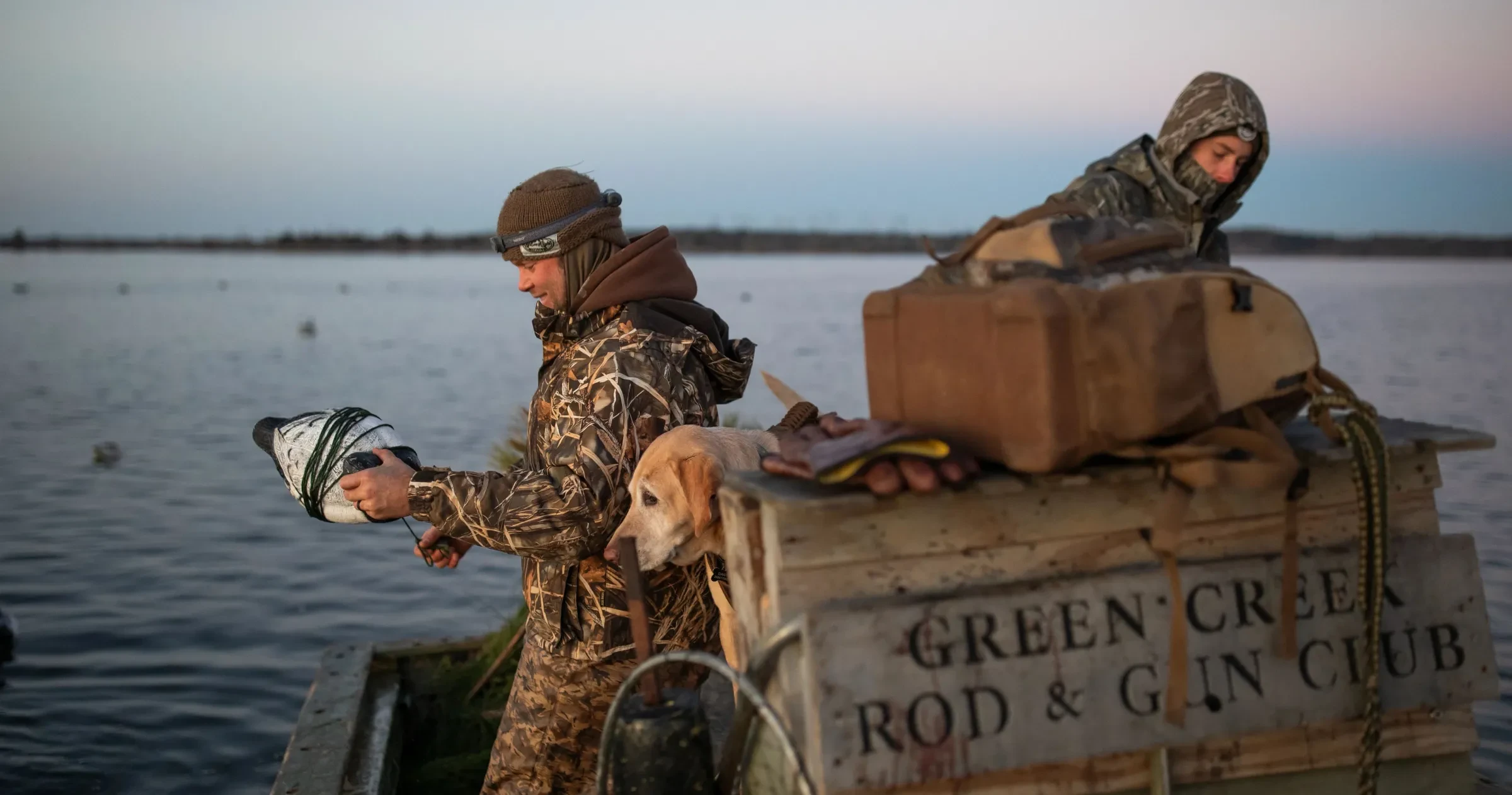 Hunter prepares to throw a duck decoy out into the water while duck hunting on the Bay River in North Carolina