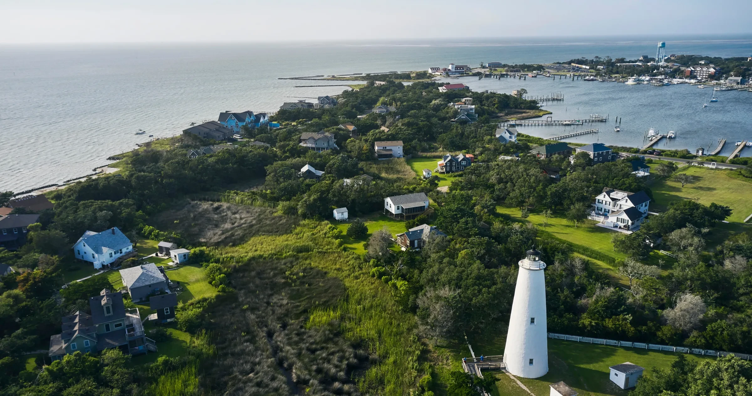Aerial view of Ocracoke Lighthouse, Ocracoke Village and Silver Lake surrounding Ocracoke Island in daytime.