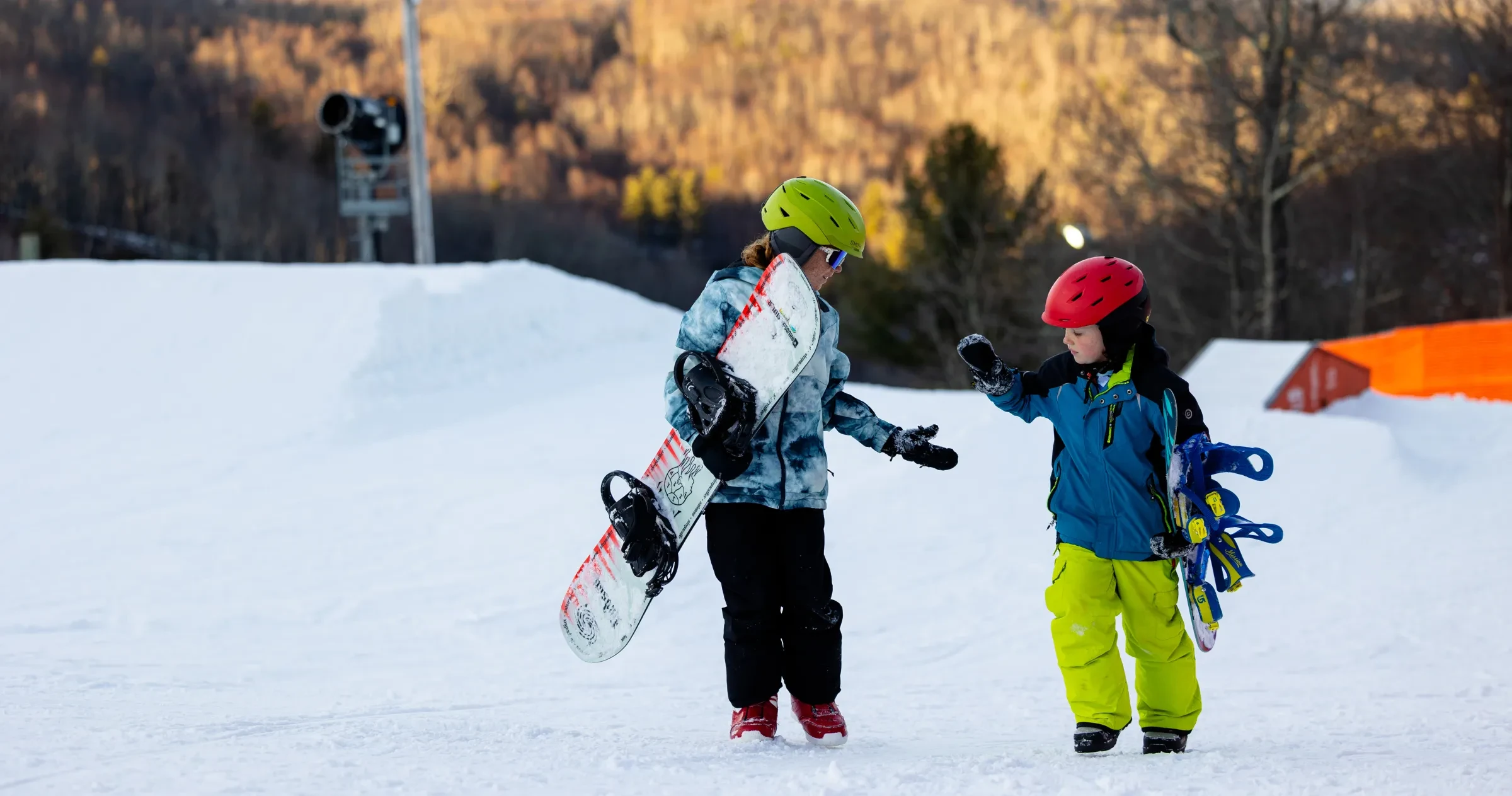 Two young snowboarders celebrate after hitting a jump at App Ski Mountain near Blowing Rock.