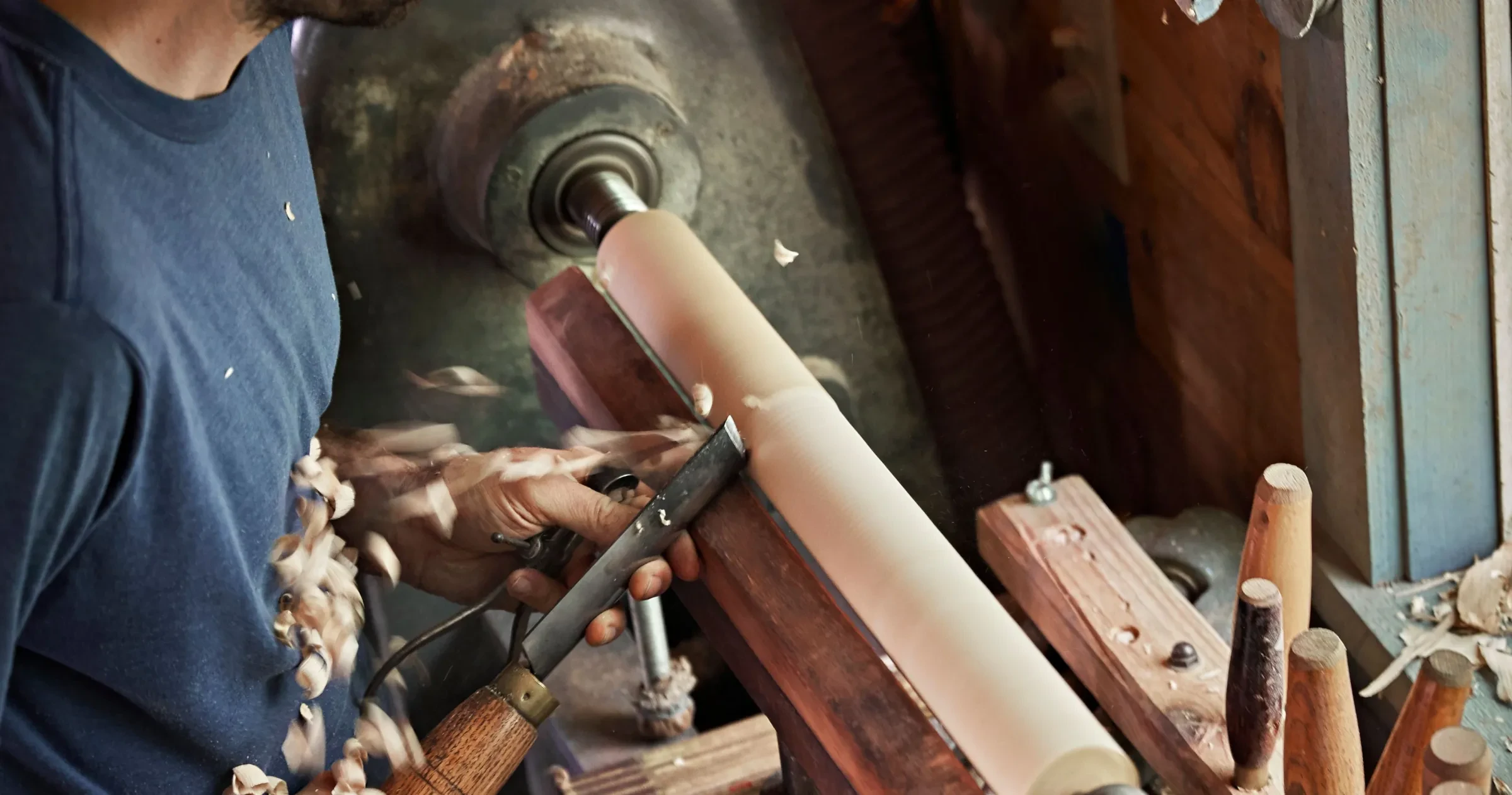 Elia Bizzarri at work, crafting a chair on a lathe at his shop in Hillsborough