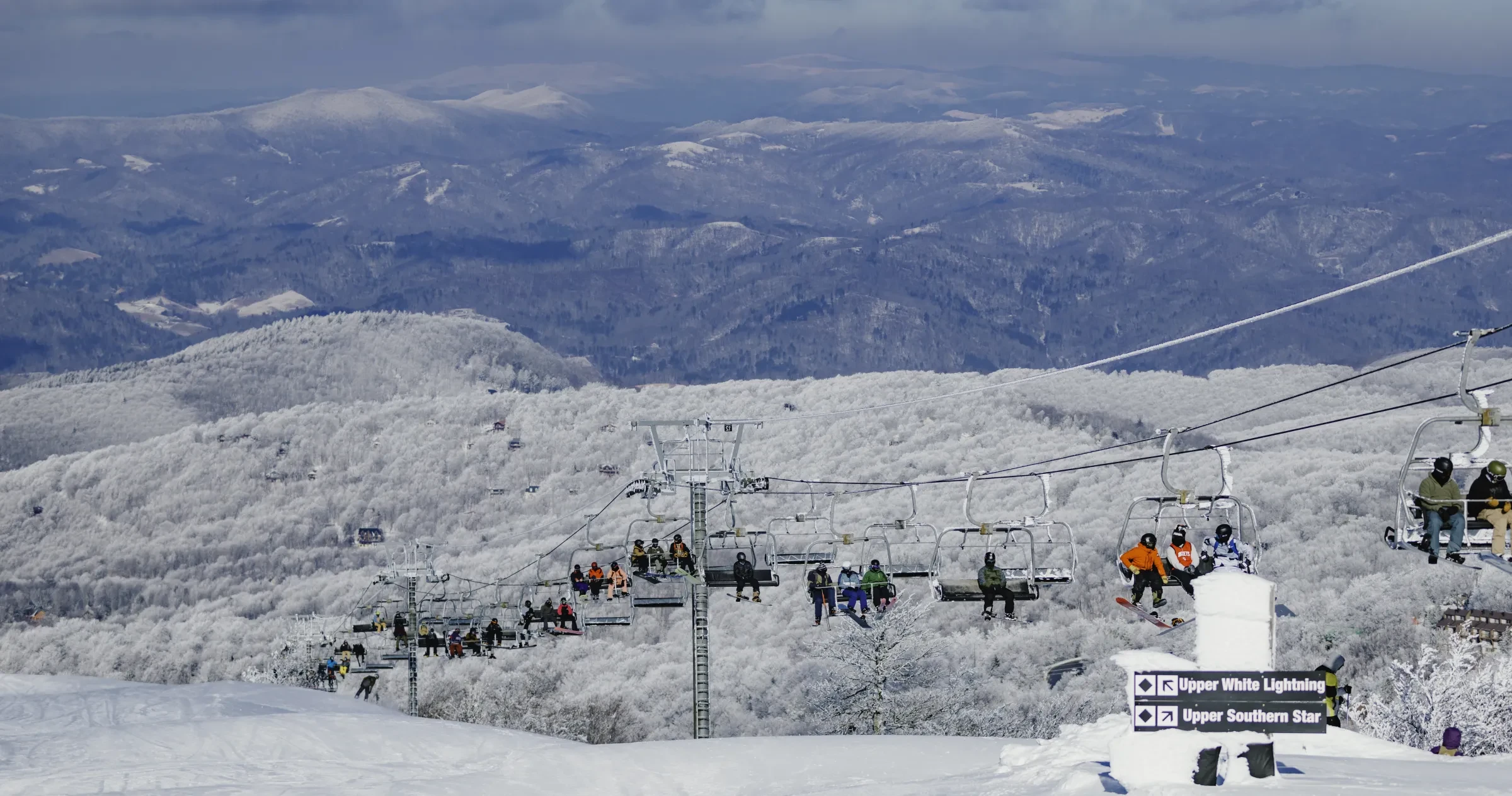 A view of the chair lift of Beech Mountain Resort outside of Banner Elk set against a wintery mountain range