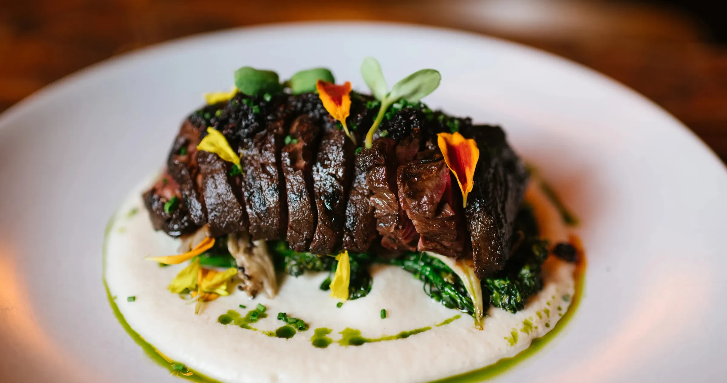 Closeup of beautifully plated meat dish at Little Bull.