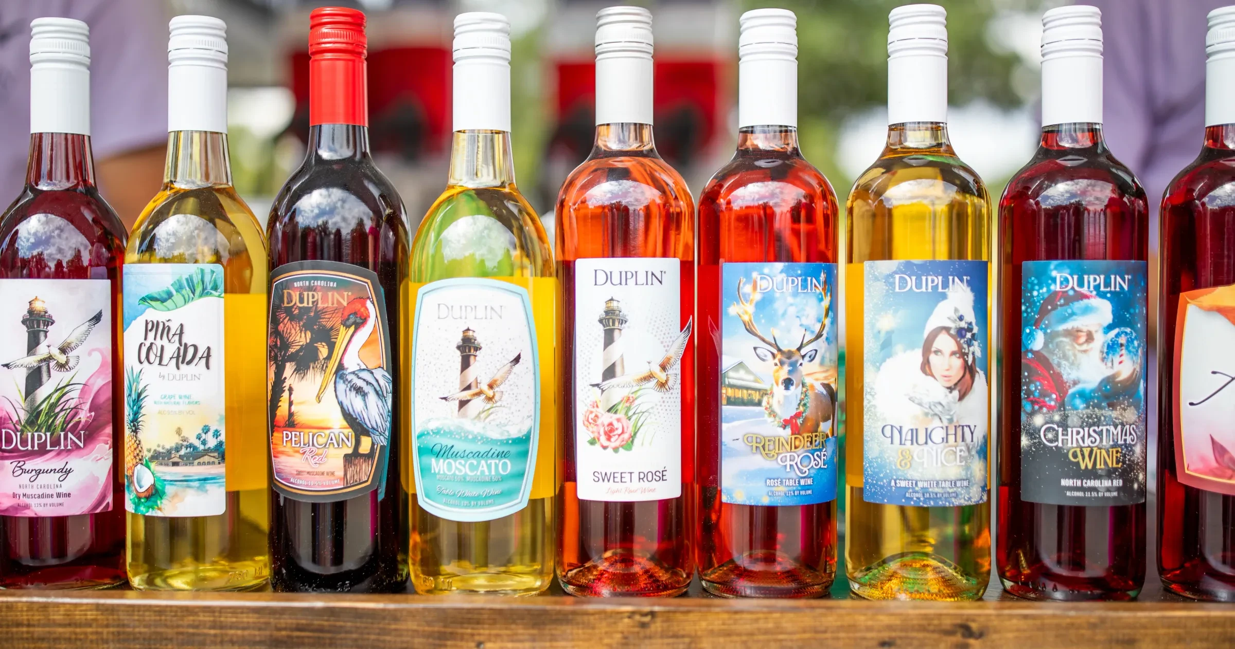 Colorful bottles of Duplin Winery wine sitting in a row on display.