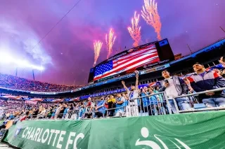 Fireworks going off above stadium with fans in foreground of Charlotte FC vs Chelsea FC.