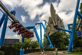 A coaster speeds along the blue track at Carowinds theme park