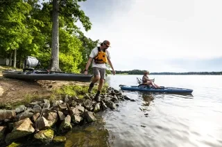 Two kayakers dip into Hyco Lake on a beautiful day