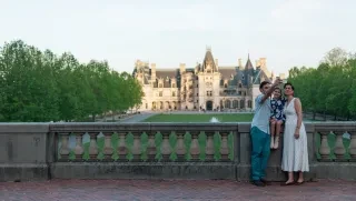 Family taking selfie in viewing area in front of Biltmore Estate.