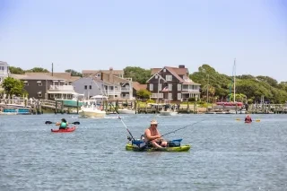 Person fishing off kayak in calm waters in Beaufort.
