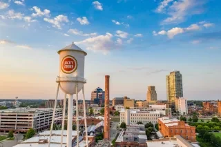 Aerial of Durham's American Tobacco Campus under beautiful cloudy sky.