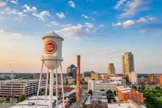 Aerial of Durham's American Tobacco Campus under beautiful cloudy sky.