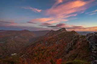 Long-range views of Linville Gorge mountains in fall under cotton candy skies.
