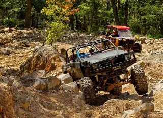 Two ATVs climb across a rough terrain as they off-road in the Uwharrie National Forest outside of Troy, NC. 