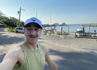 Young man running along the coastal waterway in Southport.