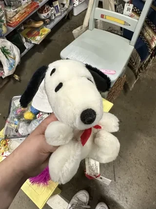 Closeup of Snoopy stuffed animal with other antiques in backgrounda at Sleepy Poet.