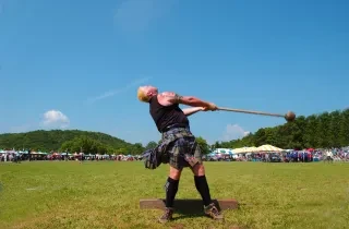 Athlete at Grandfather Mountain Highland Games competing in hammer throw.