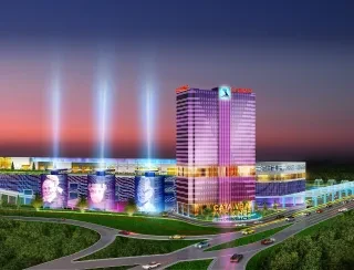 3-dimensional image of a colorful buiding aglow against the night sky with lighted portraits and highways running by.