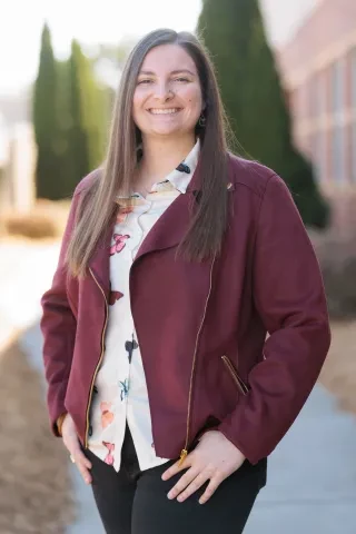 Elizabeth Clark smiling at camera for professional headshot.