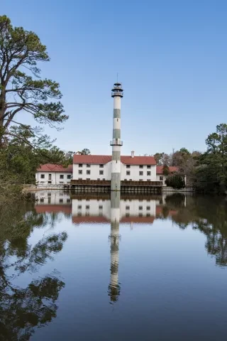 An image of Lake Mattamuskeet Lodge reflected in the still waters of Mattamuskeet National Wildlife Refuge. 