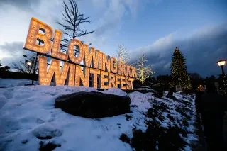 "Blowing Rock Winterfest" signage lit up under gray winter sky.