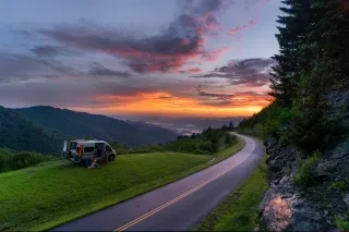 Wide view of the south end of the Blue Ridge Parkway near Waterrock Knob at sunset. People camped out in van at left of image.