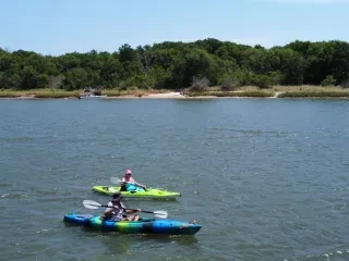 Two kayakers in waterway in Onslow County during daytime.