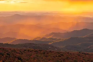 Long range view of peak fall colors in a misty atmosphere near Grandfather Mountain