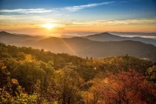 A unique overlook showcasing fall colors at sunrise along the Blue Ridge Parkway, just outside Brevard, in the Pisgah National Forest.