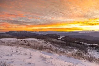 Snowy Max Patch with stunning vista views in distance as sun sets. 