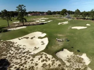 Aerial of golfers on courses at Pinehurst Resort during daytime.
