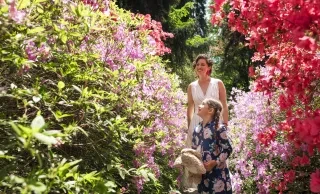 Mother and daughter walking through beautiful blooming gardens at Biltmore Estate.