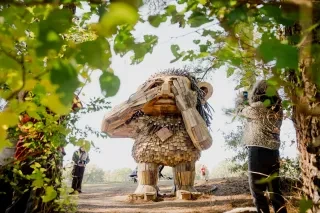 People admiring Dux troll sculpture by Thomas Dambo at Dix Park in Raleigh.