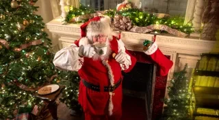Santa sips milk from a festive mug in Korner's Folly in Kernersville