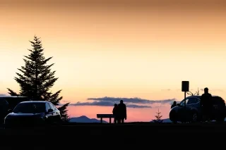Silhouette of people admiring sunset at Waterrock Knob off Blue Ridge Parkway.
