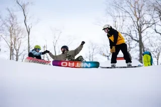 Snowboarders celebrate a run at App Ski Mountain outside of Blowing Rock