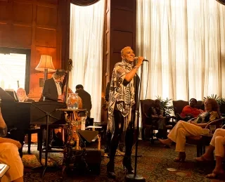 Woman performing jazz at O.Henry Hotel while guests watch the show.