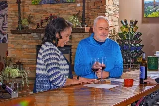 Couple drinking wine inside at bar at Banner Elk Winery & Villa.