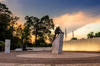 Montford Point Marines Memorial with greens in background as sun sets.