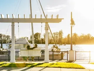 Couple swinging along waterfront in Downtown Washington along the Pamlico River.