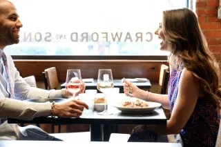 Man and woman dining at Crawford and Son restaurant.