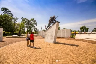 Two people observing memorial in outdoor gardens